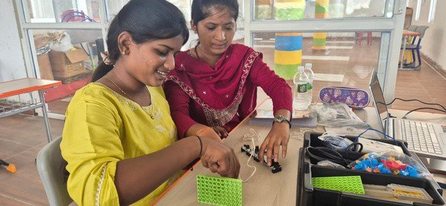 Teachers assembling a robotics project